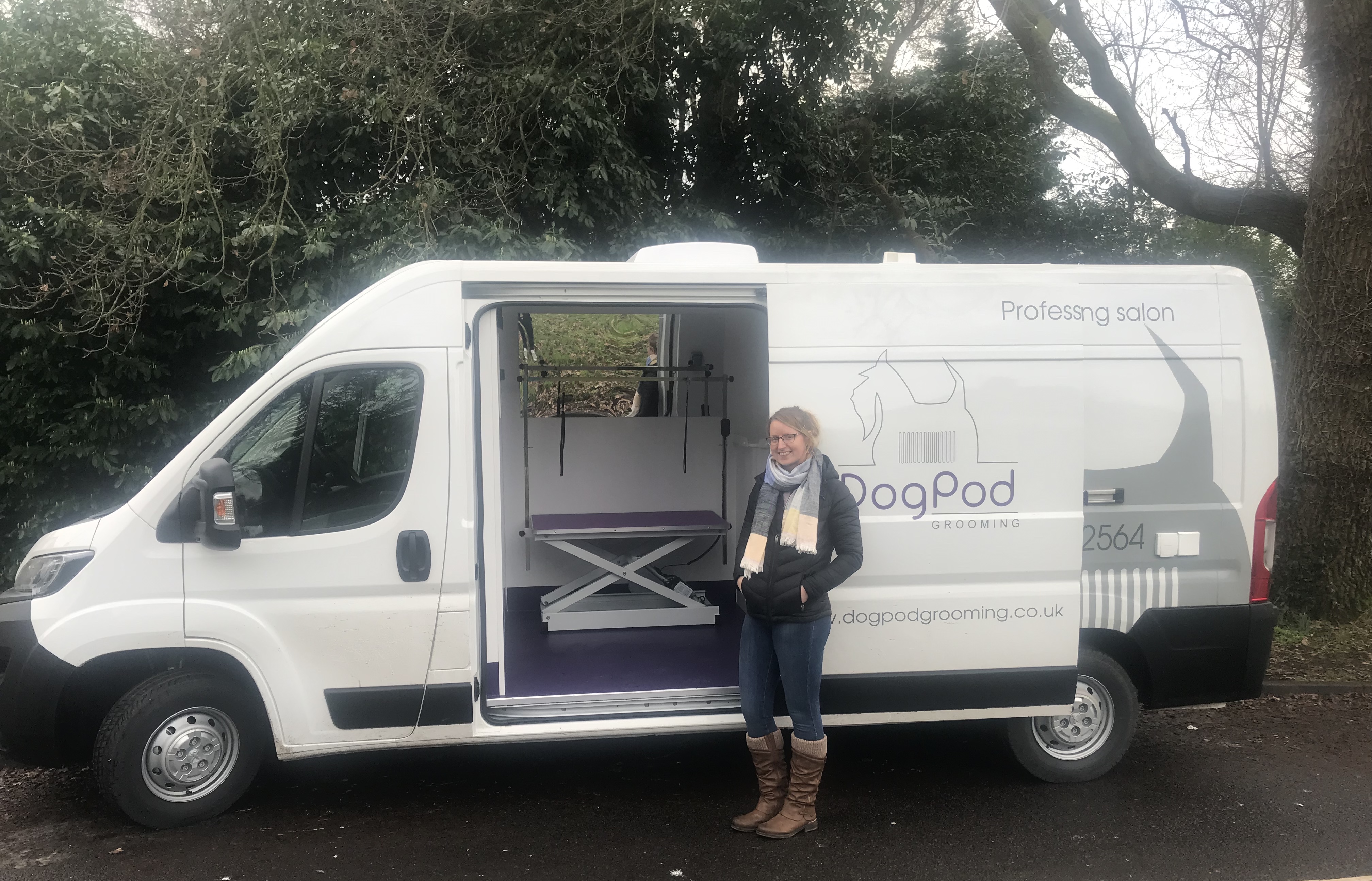 Dog Pod owner and groomer Siân Terry standing beside the mobile grooming salon